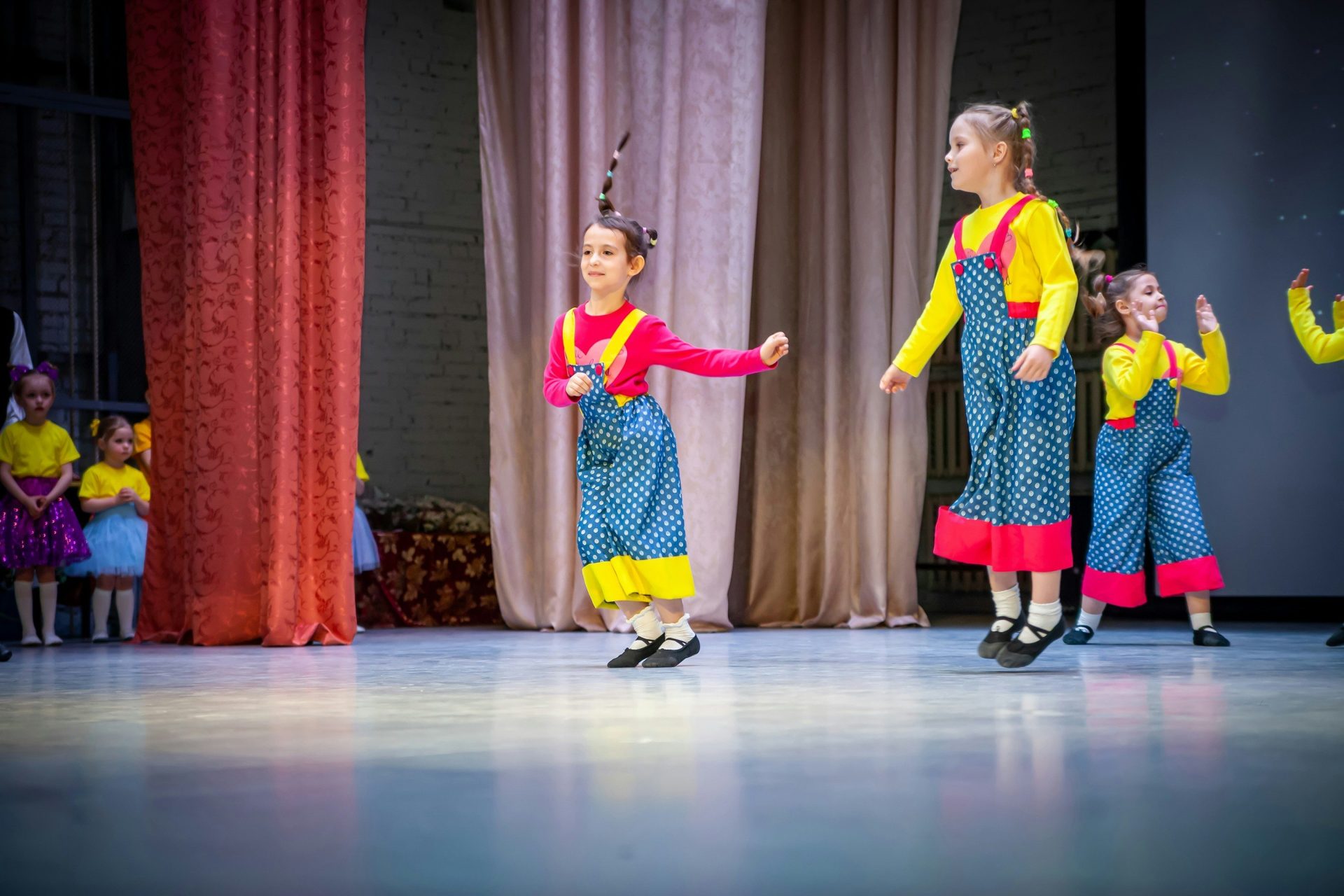 a group of children performing on a stage